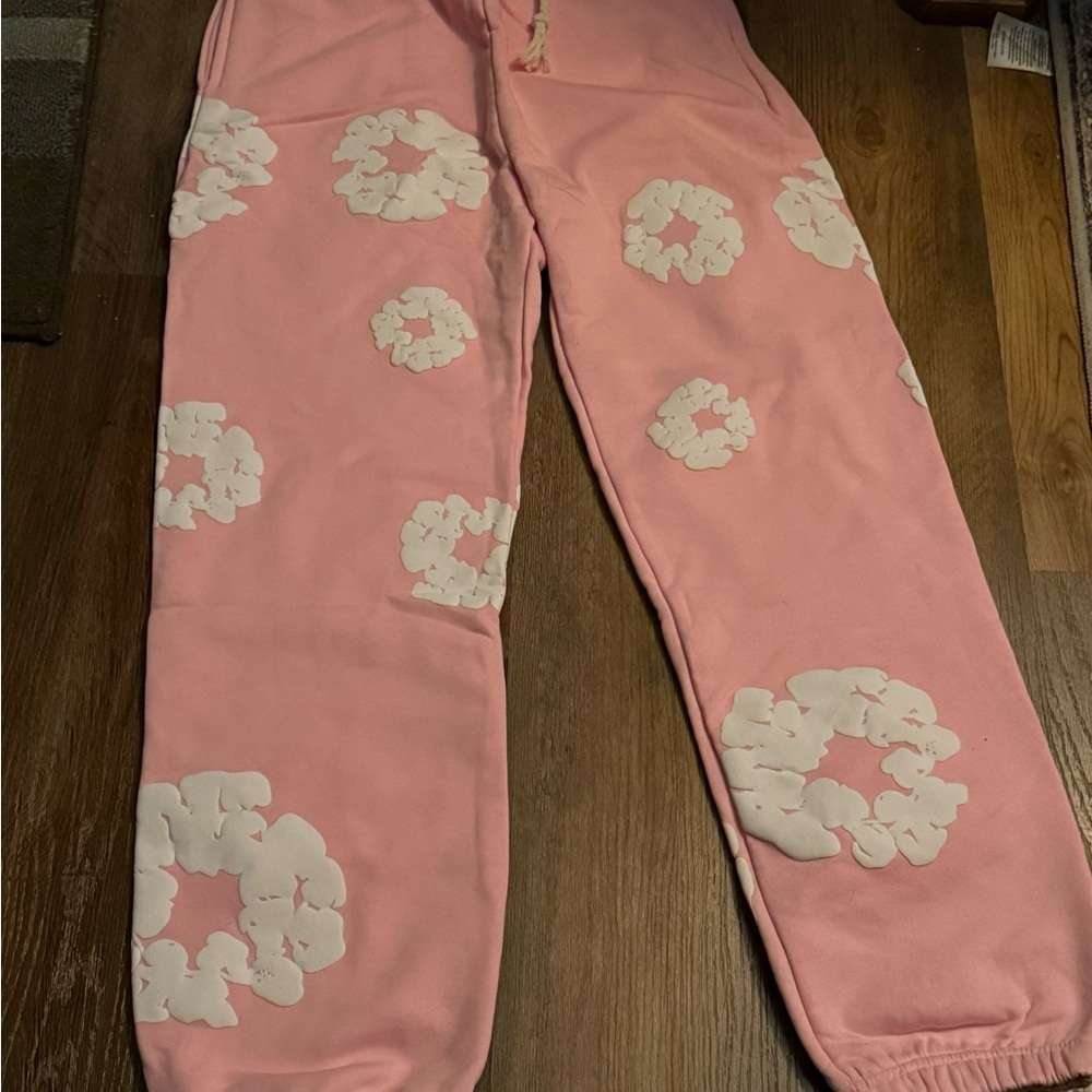 Denim Tears Stylish Pink Joggers with White Floral Design